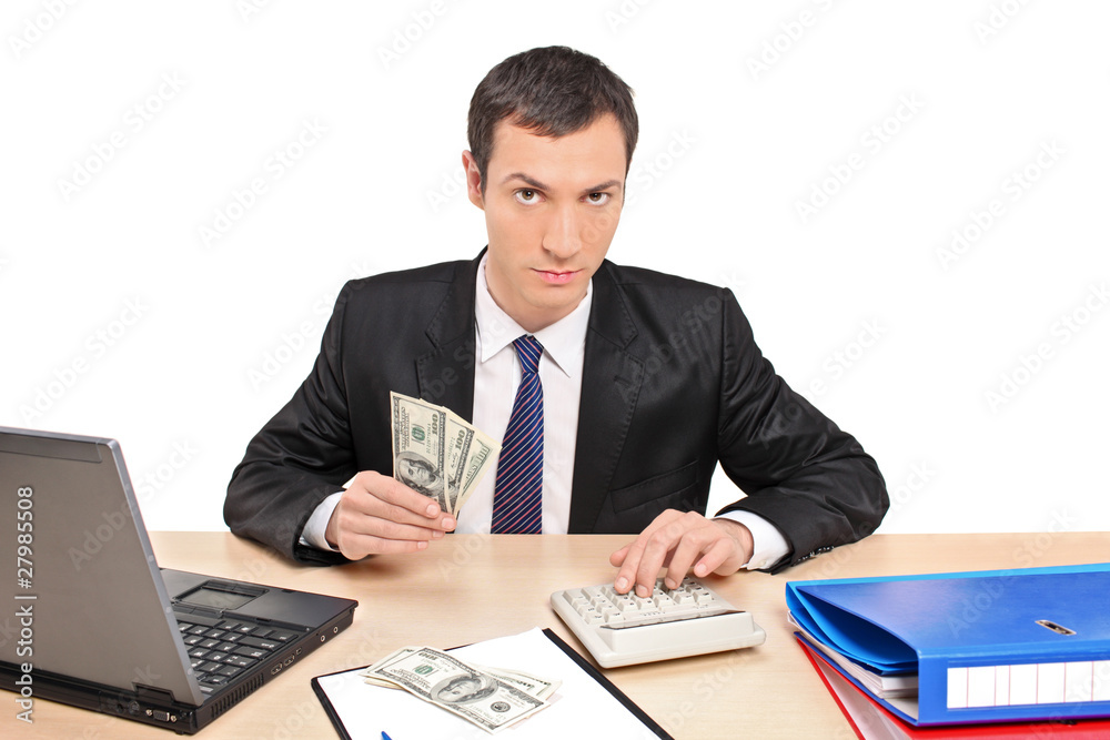 A view of a businessman counting money in his office A view of a businessman counting money in his office