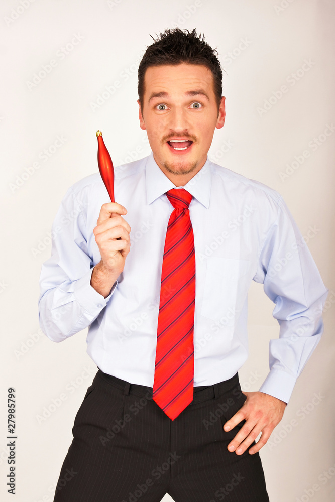 Young man shows Christmas ornament