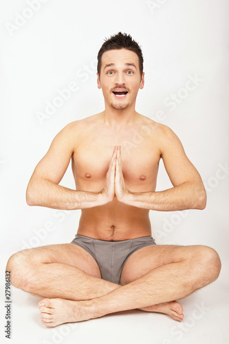 Young man is making yoga.
