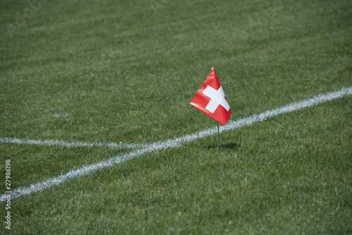 Schweizerfahne auf Rasenspielfeld photo