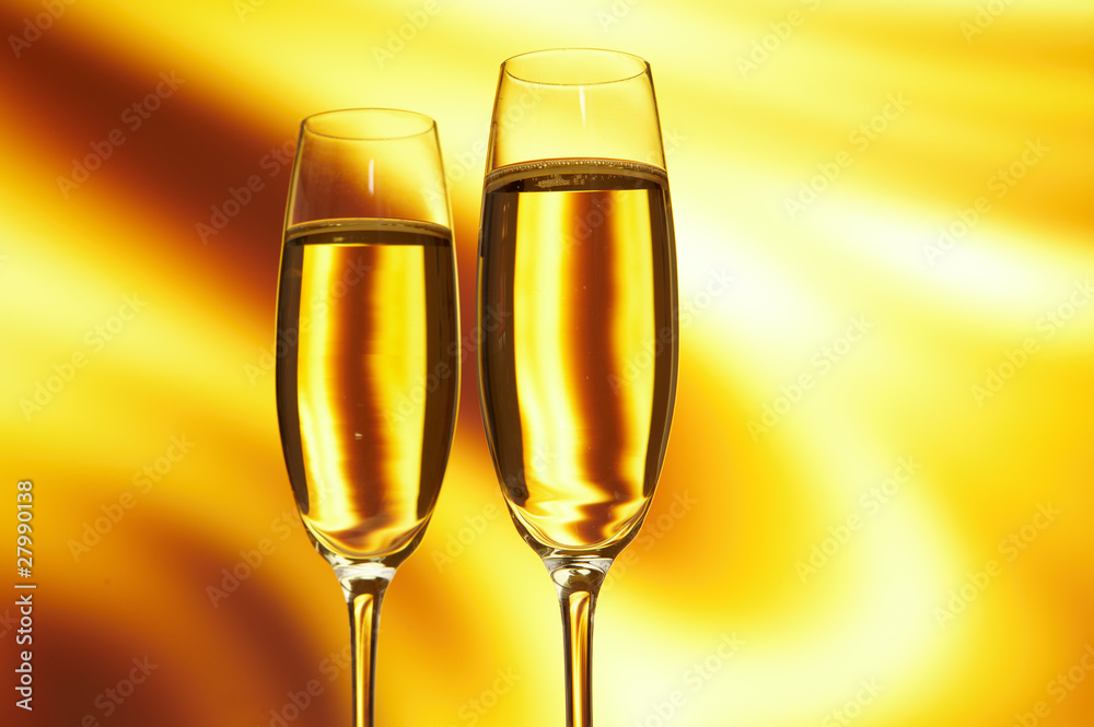Glass of champagne against golden background Glass of champagne against golden background