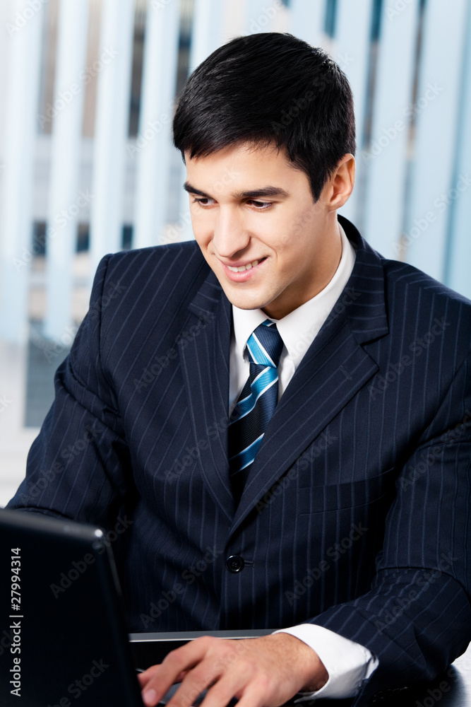 Successful happy smiling businessman working with laptop Successful happy smiling businessman working with laptop