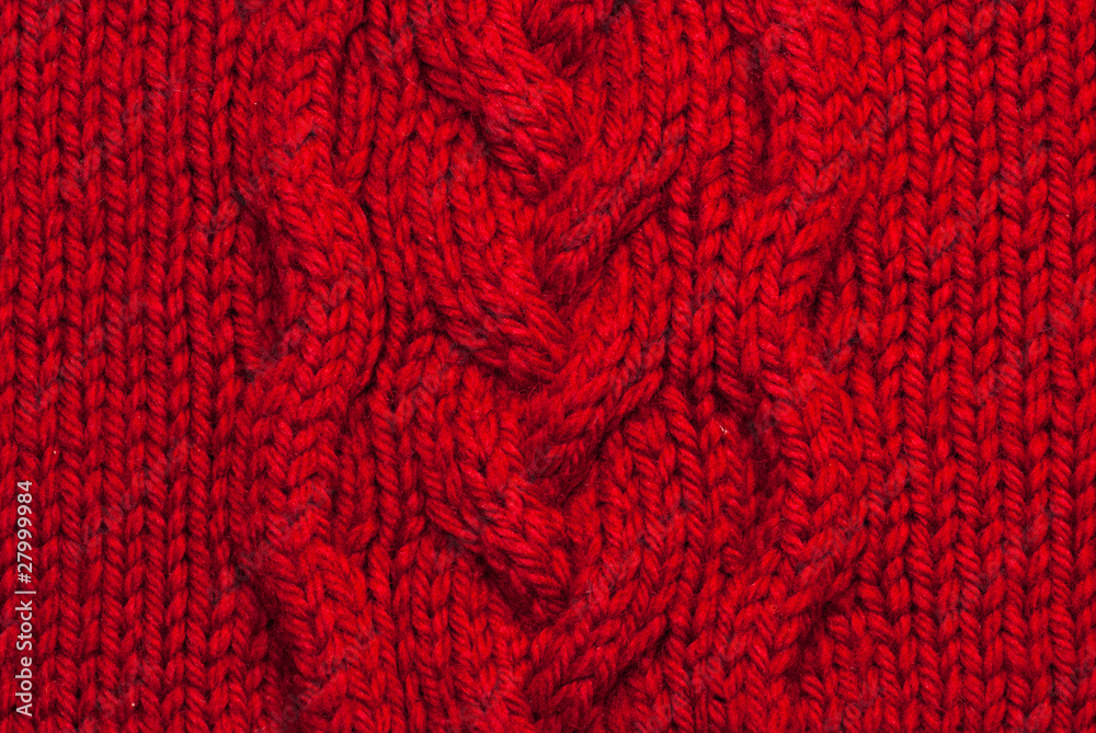 Red knitting background of handmade woolen pattern