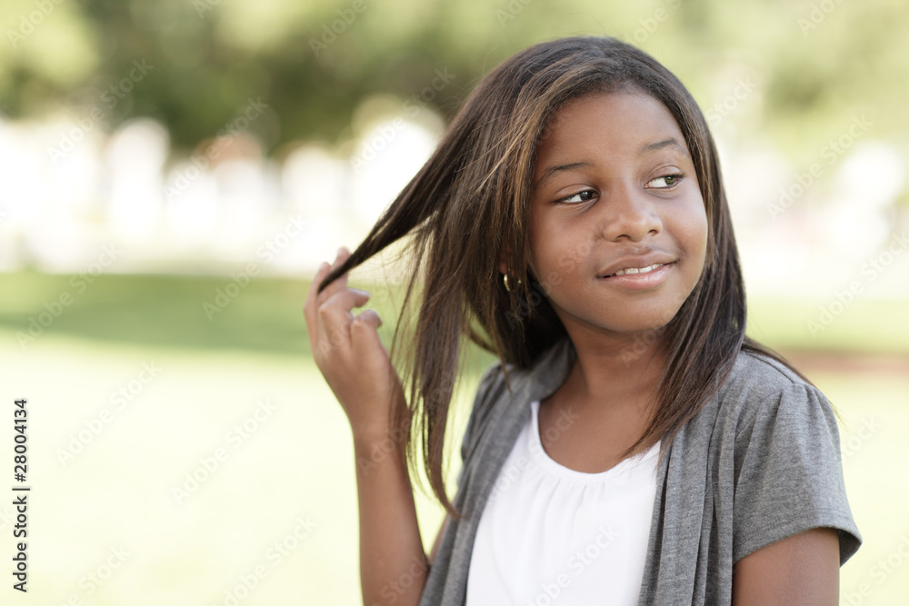 Young girl playing with her hair