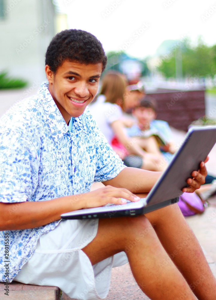 A smiling african american man on his laptop A smiling african american man on his laptop