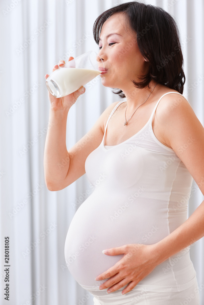 Pregnant lady drinking milk Pregnant lady drinking milk