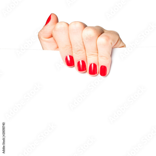Fotografija Beautiful female hand with red nails holding a blank sign