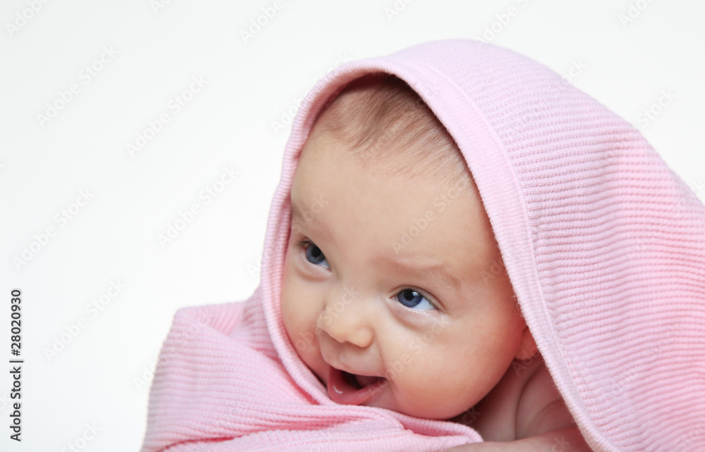 Baby girl smiling under a pink blanket Baby girl smiling under a pink blanket