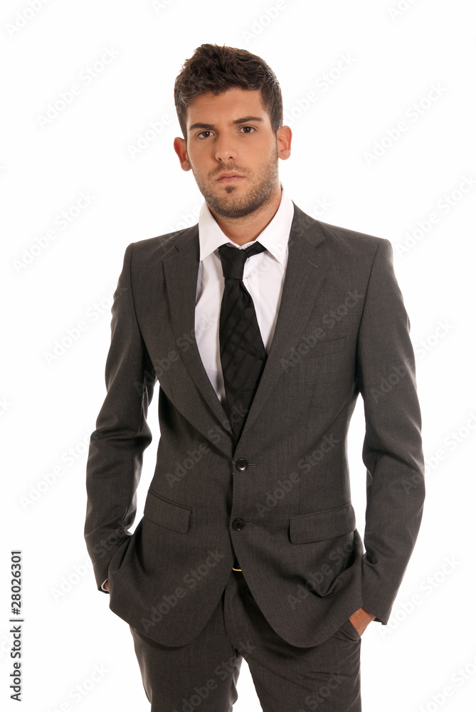 Young businessman looking serious hands in pockets isolated Young businessman looking serious hands in pockets isolated