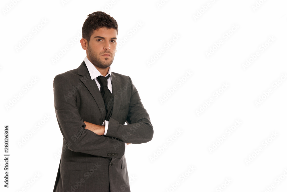 Young businessman with copy-space looking serious arms crossed Young businessman with copy-space looking serious arms crossed