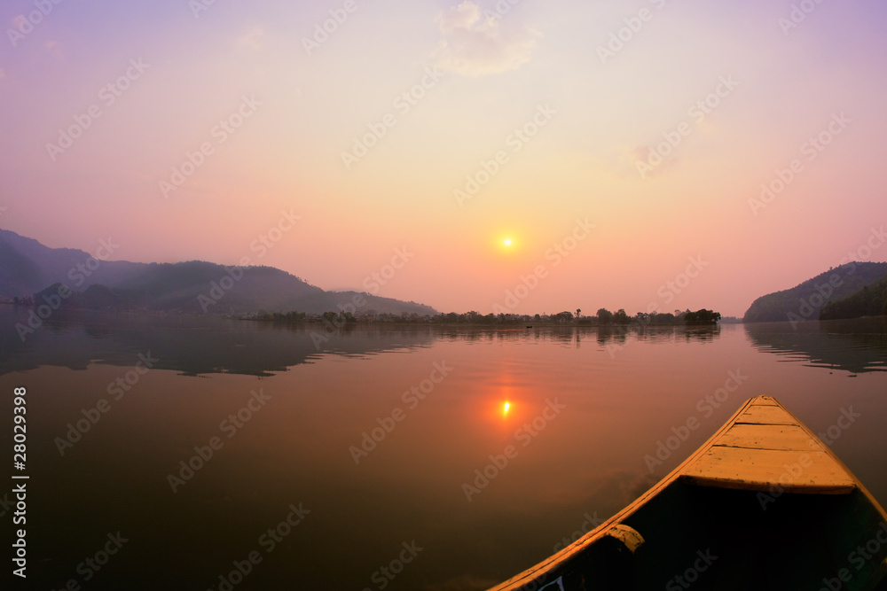 Beautiful sunrise landscape from boat view on Phewa lake, Pokhar
