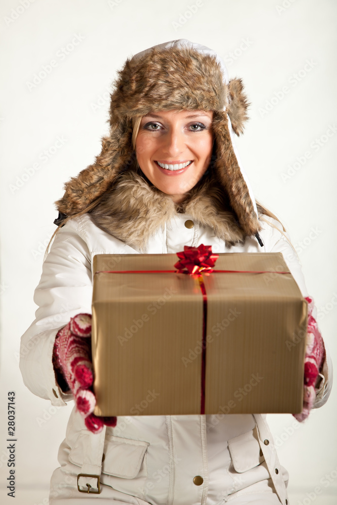 Caucasian blond woman in furry hat and christmas gifts isolated
