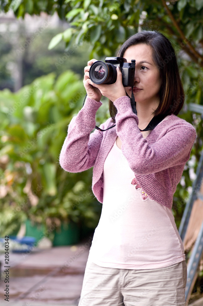 portrait of young woman and camera in bangkok city