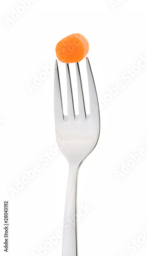 Slices of carrot on fork isolated on white background