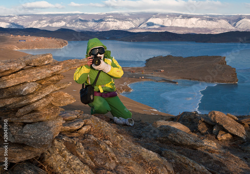 The girl the photographer on mountain about Baikal