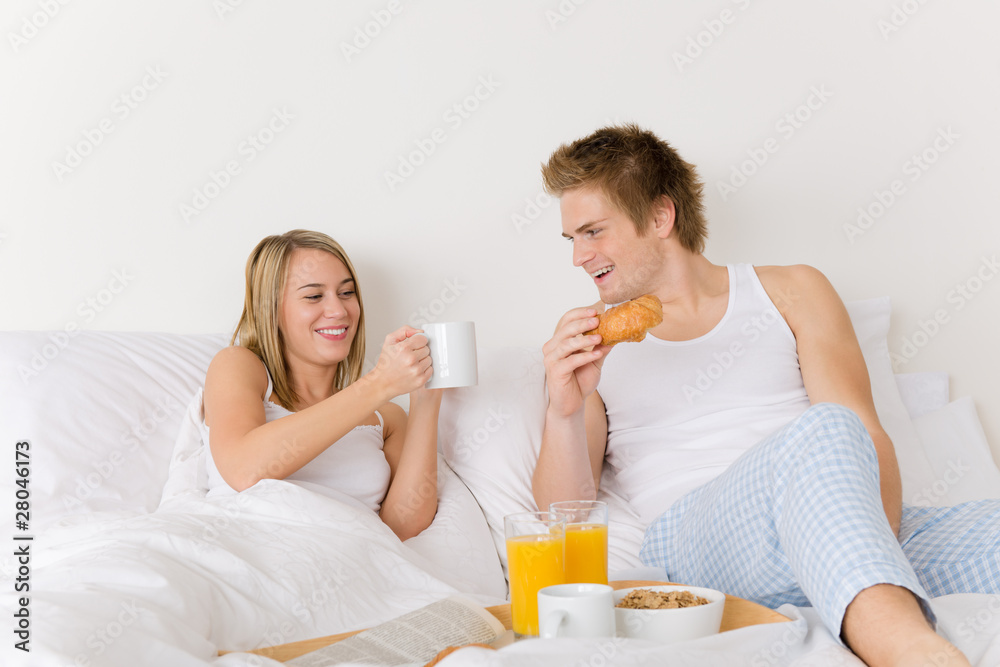 Luxury hotel honeymoon breakfast - couple in bed Luxury hotel honeymoon breakfast - couple in bed