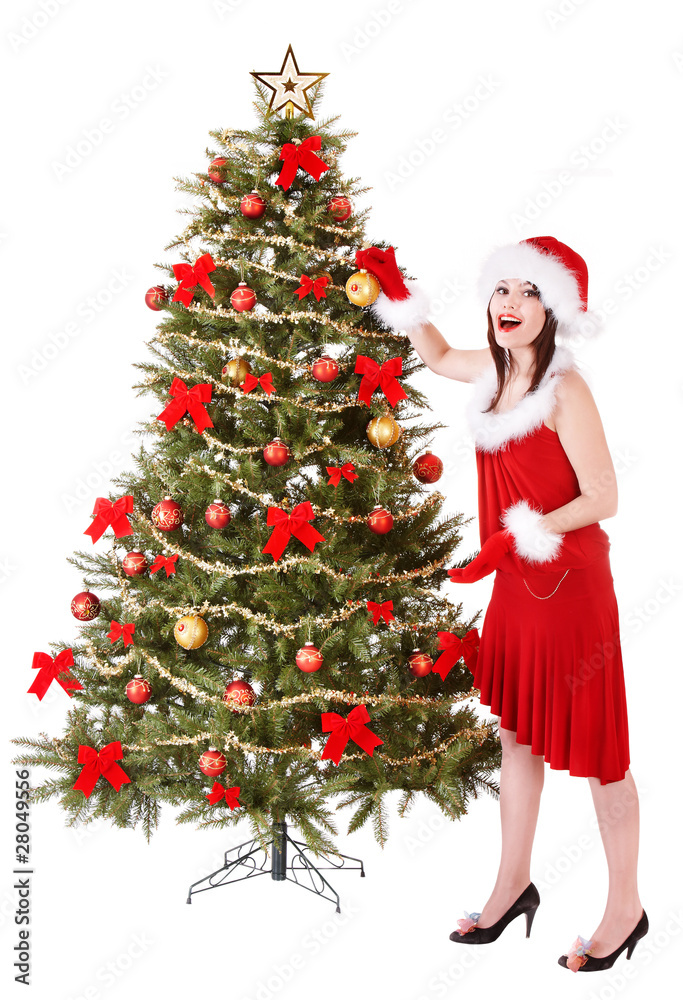 Girl in santa hat decorete christmas tree. Isolated.