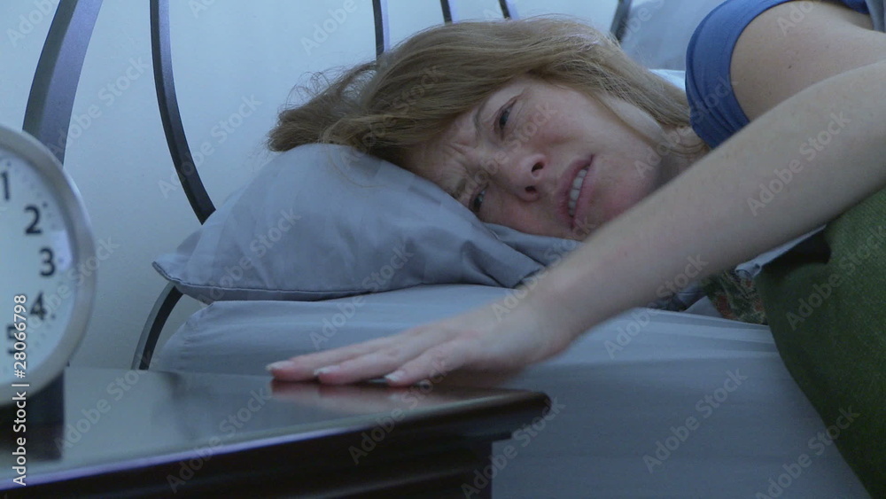 Woman getting out of bed in the morning Woman getting out of bed in the morning