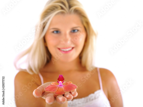 Beautiful young fresh female holding a flower. focus on flower.