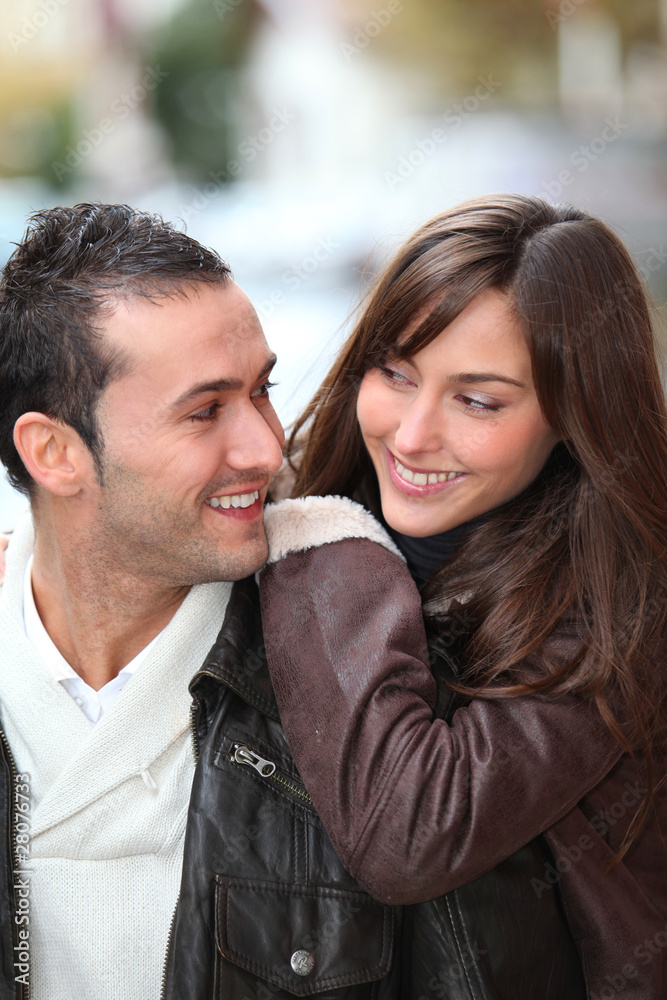 Young couple shopping in town in winter Young couple shopping in town in winter