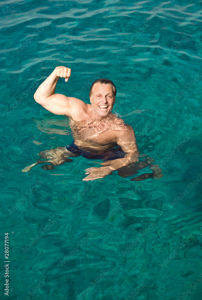 happy laughing man posing in the water