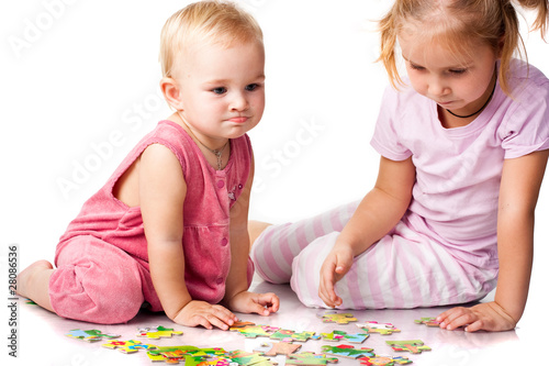 Children solving jigsaw puzzle