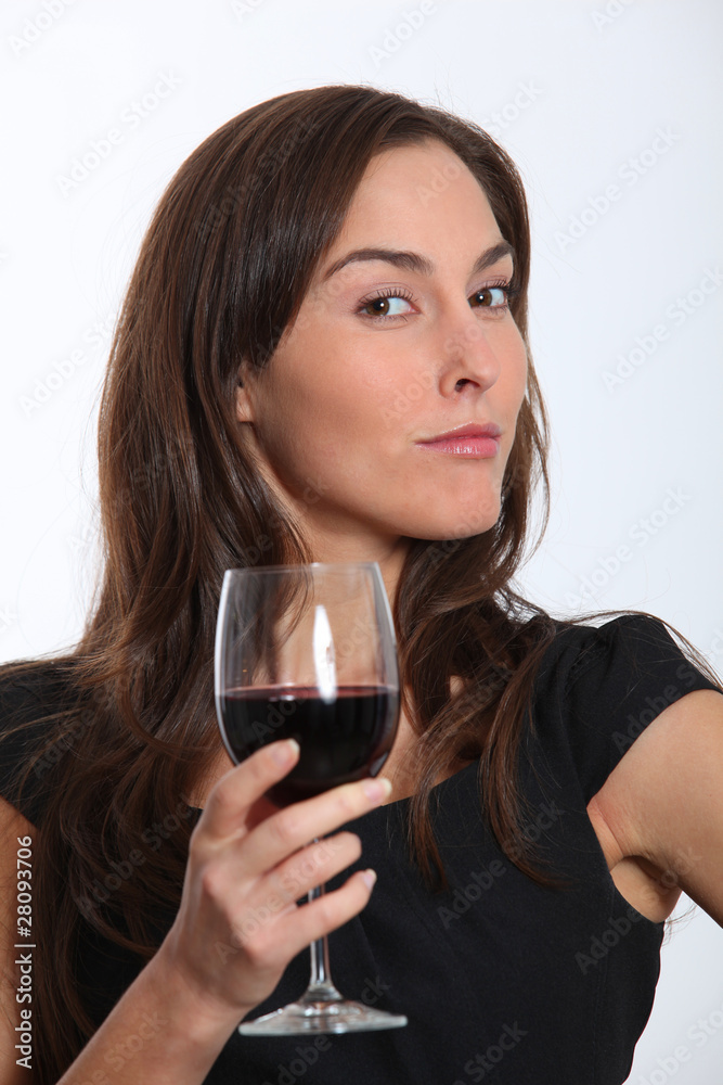 Beautiful woman in black dress tasting red wine Beautiful woman in black dress tasting red wine