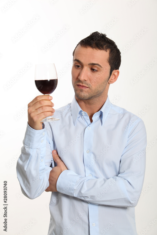 Young man on white background tasting red wine Young man on white background tasting red wine