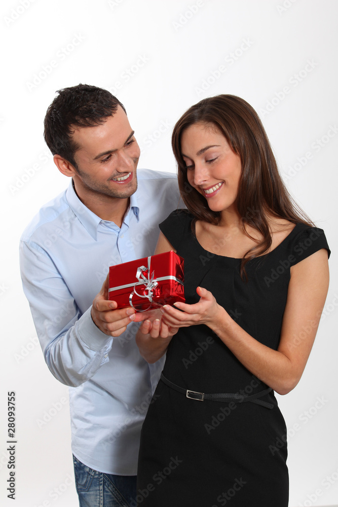 Man offering present to girlfriend Man offering present to girlfriend