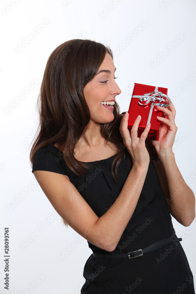 Smiling young woman with christmas gift Smiling young woman with christmas gift
