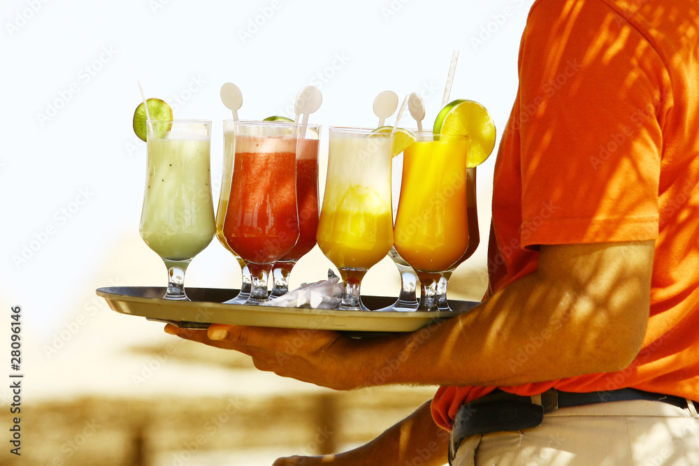 Waiter serving drinks / cocktails on the beach