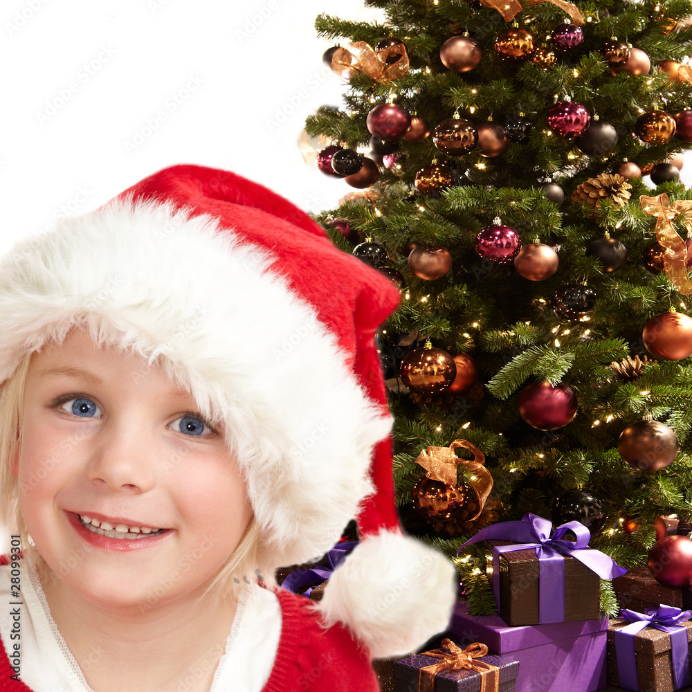 Cute girl with Santa Claus hat with christmas tree Cute girl with Santa Claus hat with christmas tree