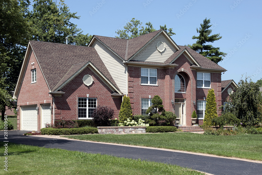 Luxury brick home with arched entry