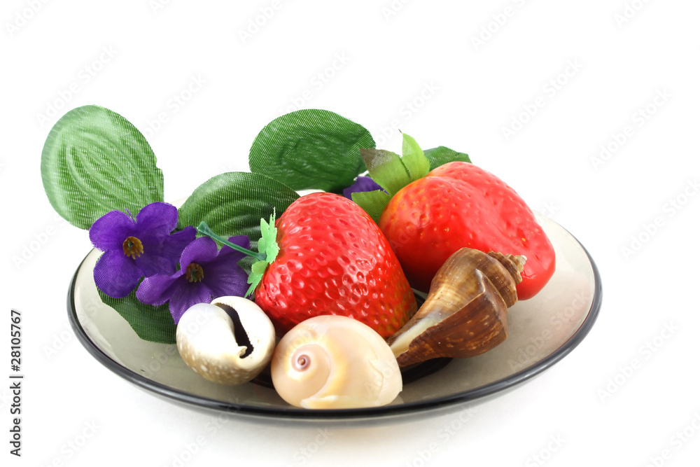 Artificial flowers, strawberries and sea shells on saucer. Artificial flowers, strawberries and sea shells on saucer.