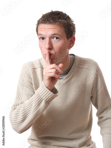 young man with finger on lips isolated over white