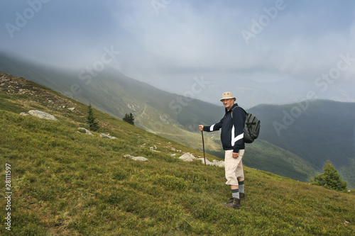 older man walking on beautiful mountain