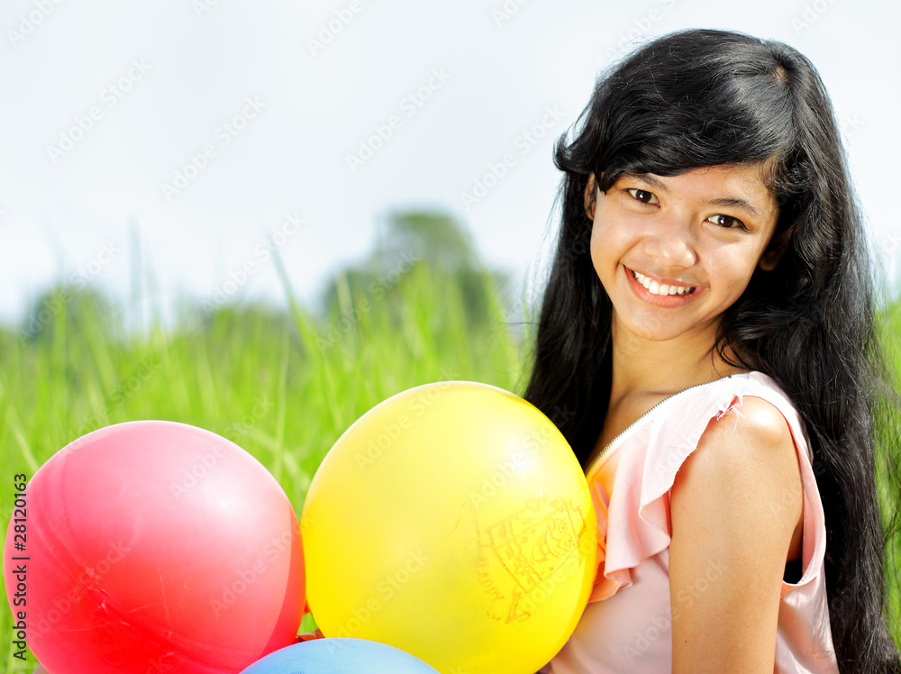 Exotic Teenage Girl smiling with colorful balloons in her hands Exotic Teenage Girl smiling with colorful balloons in her hands