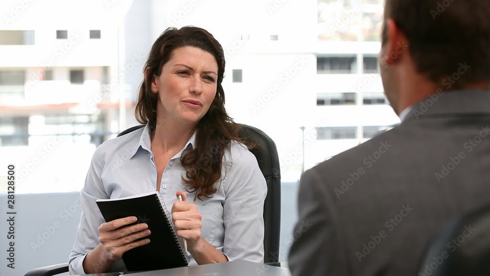 Businesswoman questioning a man during an interview Businesswoman questioning a man during an interview