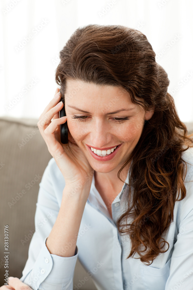 Smiling businesswoman on the phone while resting on the sofa Smiling businesswoman on the phone while resting on the sofa
