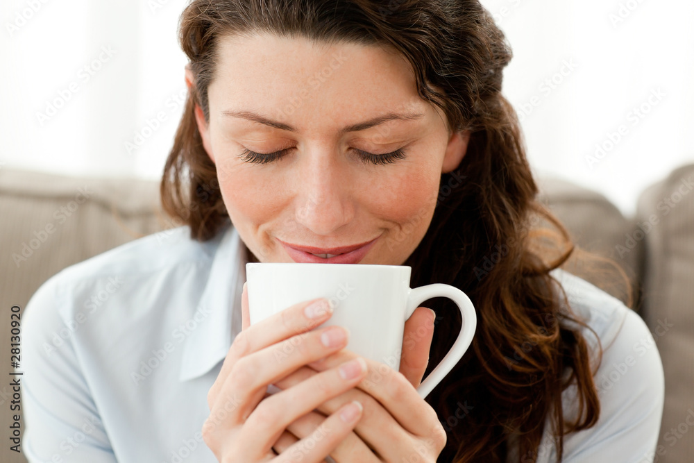 Cute businesswoman enjoying her coffee at home Cute businesswoman enjoying her coffee at home