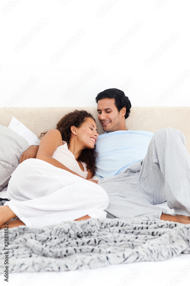 Passionate couple lying together on their bed Passionate couple lying together on their bed