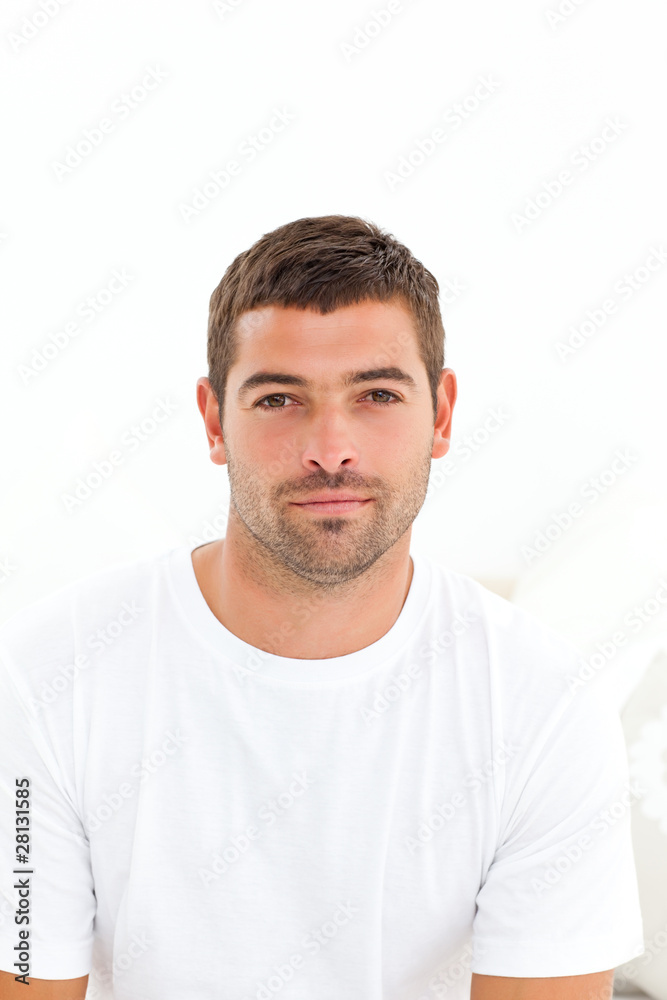 Portrait of a serious man sitting on his bed Portrait of a serious man sitting on his bed