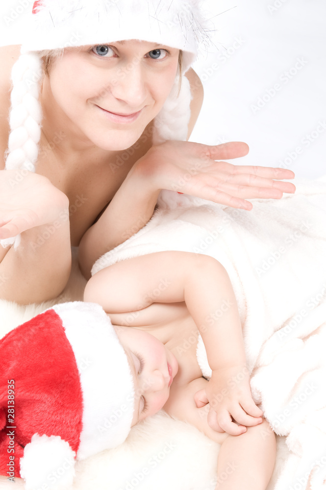 Mother and sleeping baby wearing christmas hut Mother and sleeping baby wearing christmas hut