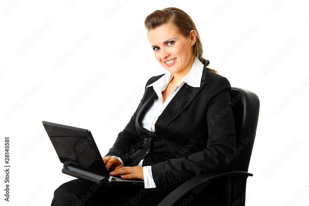 Smiling modern business woman sitting on chair and using laptop. Smiling modern business woman sitting on chair and using laptop.
