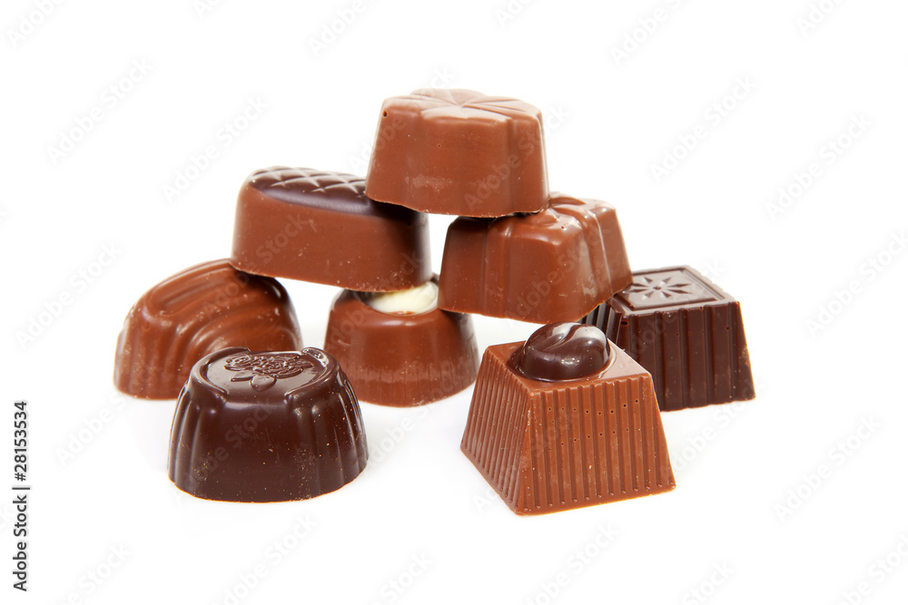 pile of chocolate bonbons over white background pile of chocolate bonbons over white background