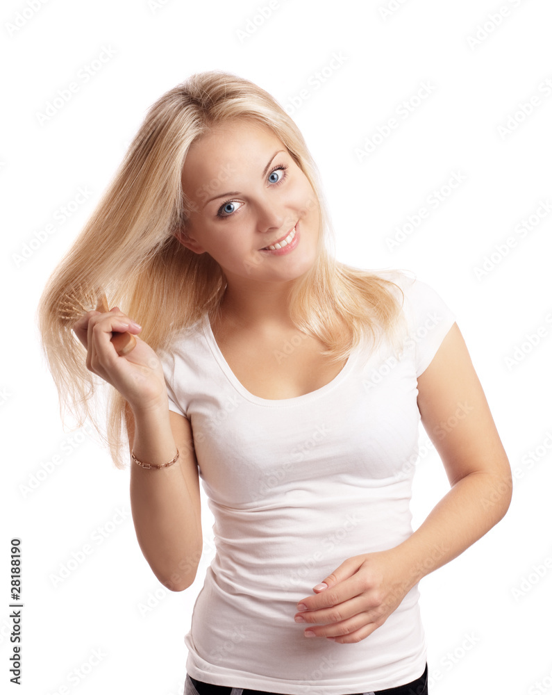 Beautiful young blonde woman brushing her long hair Beautiful young blonde woman brushing her long hair