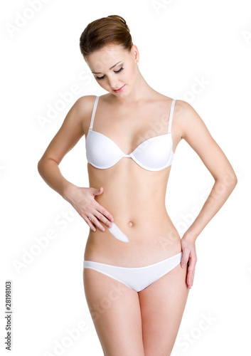woman applying cosmetic cream on abdomen © Valua Vitaly