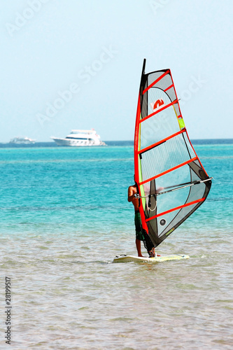 Windsurfer, blue sea and transparent sail