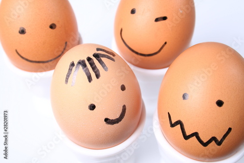 Eggs with a smiling faces on white background