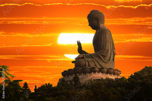 Fotografija Buddha statue at sunset